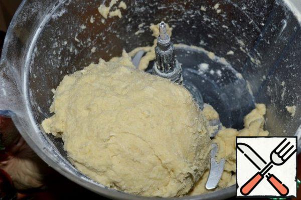 The dough will gather itself into a lump, you just need to take it out. Knead lightly, wrap in plastic wrap and refrigerate while the filling is being prepared.