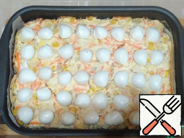 Then get the form with the casserole, spread out on top of the mozzarella balls (20 PCs), cut in half.