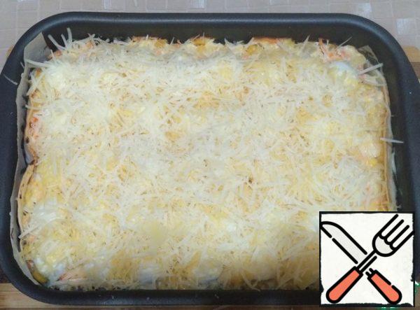 Grate the hard cheese and parmesan on a fine grater, mix and sprinkle the casserole.