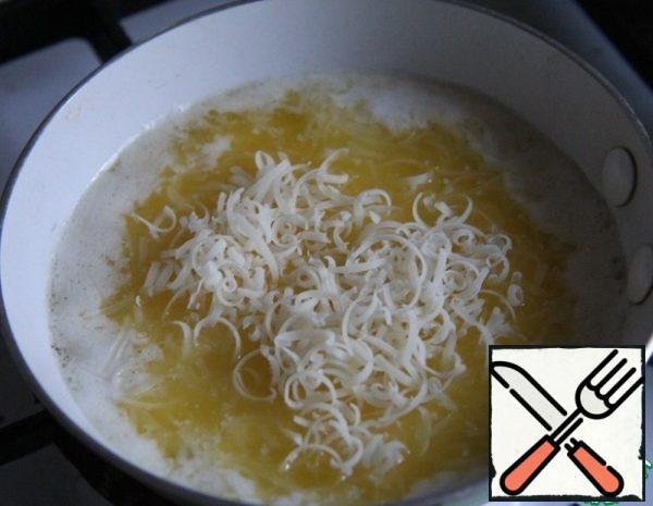 Melt the butter. Add finely grated hard cheese to the hot butter.