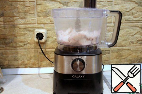 Boil the breast and chop it in a food processor with a chopper knife.