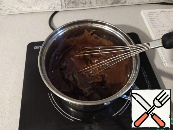 Bring the mass to a boil and cook constantly stirring until thick. Remove from the heat, add the chocolate pieces and stir until they dissolve, cover with cling film and allow to cool to room temperature, and then put in the refrigerator for a couple of hours.