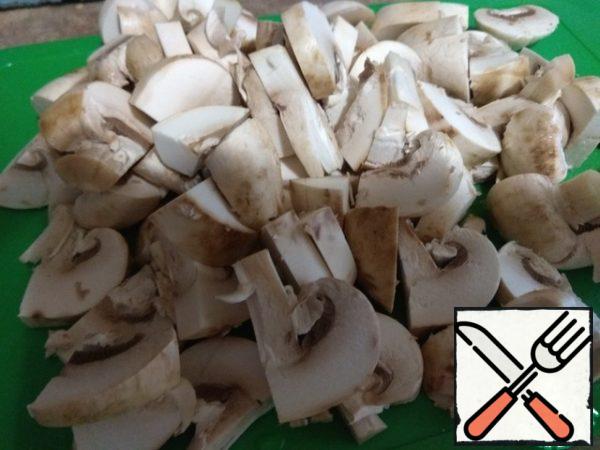 Mushrooms are washed and cut into four parts (mushrooms come across small).