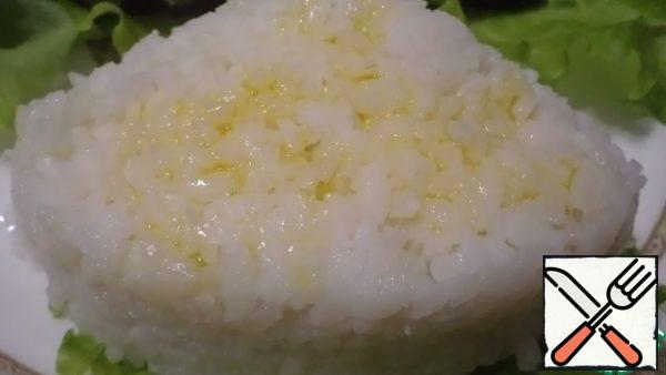 Boil the rice in a water ratio of 1:1.5. Put the rice in a cup or in a greased form and transfer to a plate.