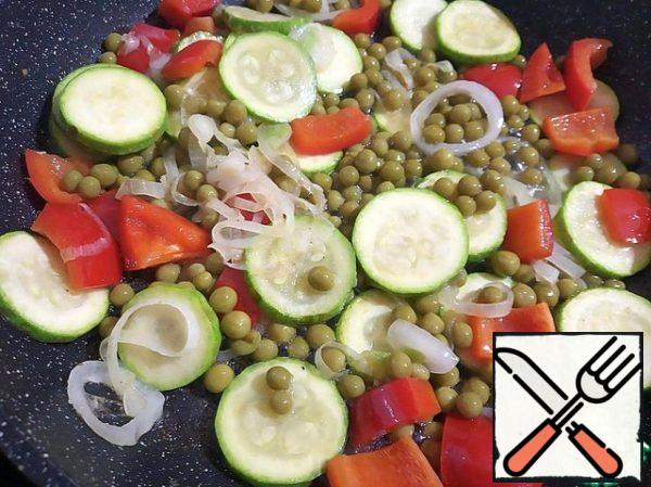 Add the green peas to the pan and mix gently.