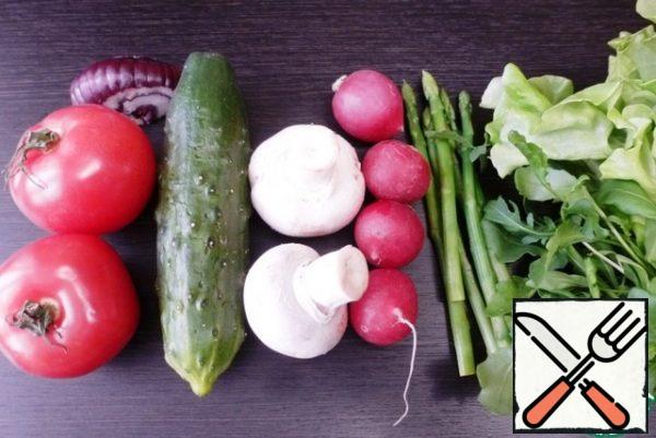 Prepare the vegetables for the salad. Wash and clean them.