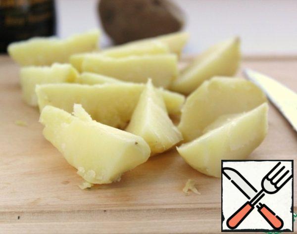 Boil potatoes in a uniform, peel and cut into large slices. Even better, if the potatoes are baked in the oven.