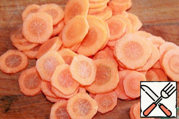 Wash the carrots, peel them and cut them into thin circles.