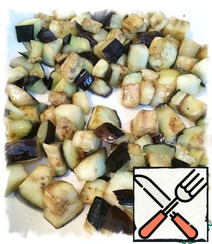 Fry the eggplant cubes in olive oil until half-cooked (5 minutes) and transfer to a separate bowl.