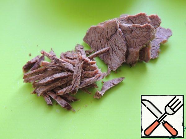 Boil the meat until tender. Cut into strips.