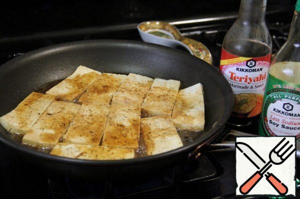 Cook for about 2-3 minutes, then turn and pour soy sauce and teriyaki sauce on the other side. And cook for another 2-3 minutes.