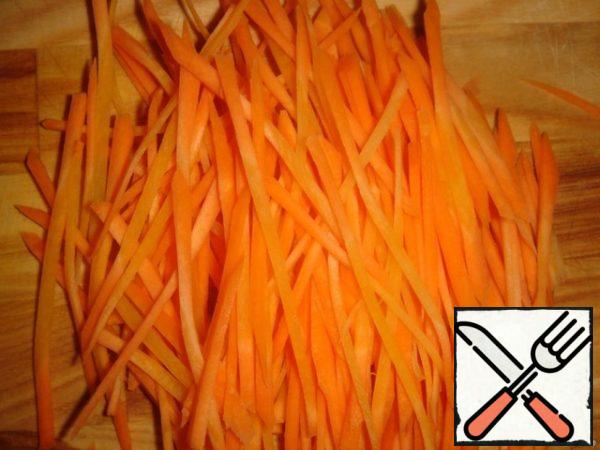 Slice the carrots into thin strips.