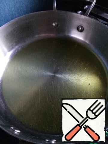 Pour olive oil into a high skillet.