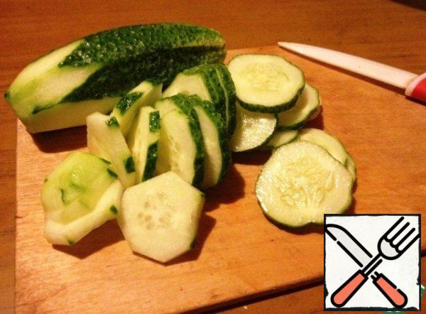 Wash the cucumbers, dry them, and cut them into thin slices.