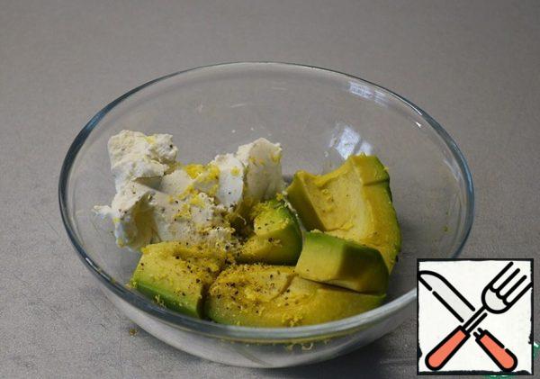 Peel the avocado, add soft curd cheese, pepper, and a little lemon zest.