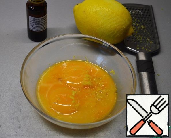 Add vanilla essence and lemon zest to the yolks.
