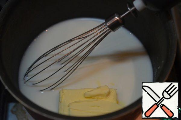 In the milk, melt the butter over a low heat.