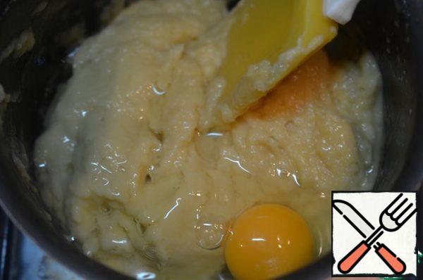 Beat the eggs one at a time, mixing well each time.