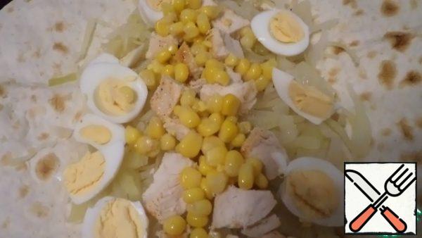 Boil the eggs, open the corn. In the middle of the pita bread, put boiled or fried cabbage, pieces of baked chicken, eggs, corn and smear with mayonnaise.