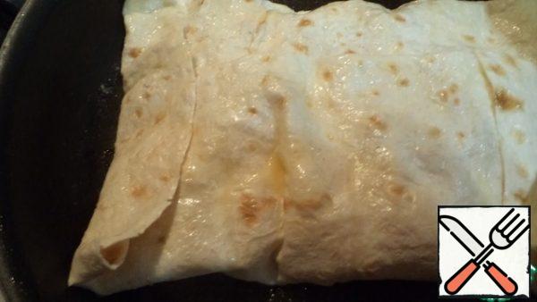Roll up the pita bread in the form of an envelope and fry in a frying pan with oil.