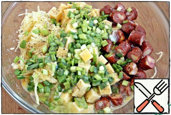 Add chopped green onions or your favorite greens, salt and pepper to your taste. Then in a bowl with a fork, beat the eggs (do not salt) and add to the potatoes, cheese, sausage.