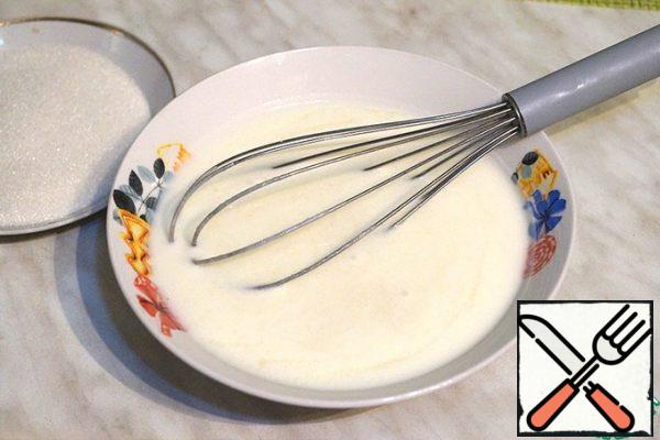 Add the remaining sugar to the yogurt and whisk with a whisk.