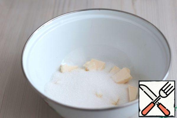 In a bowl, put butter at room temperature (100 g), add sugar (180 g).