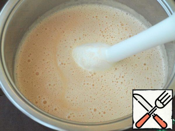 Using an immersion blender, puree the soup.