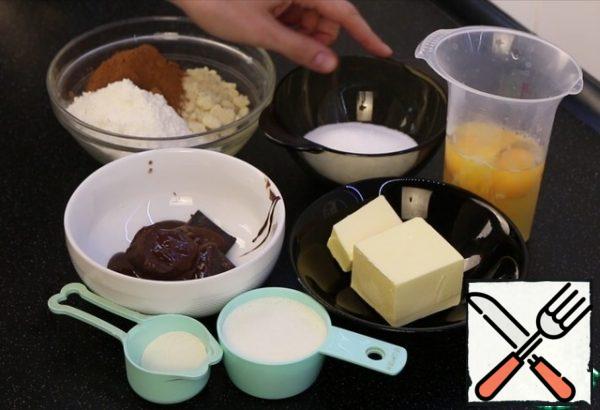 First of all, prepare a biscuit.
Cream from 30% fat content.
Dark chocolate, I have 62% cocoa. Melt.
Eggs and butter at room temperature.
Sift the dry ingredients.
