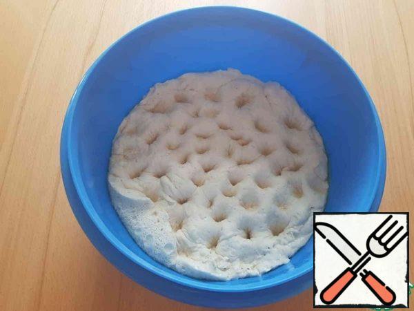 Now, using your thumb, press the dough so that all the extra air comes out.