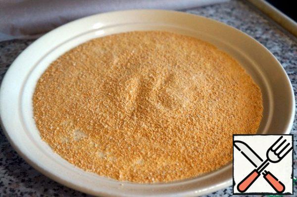 Pour the breadcrumbs onto a flat dish.