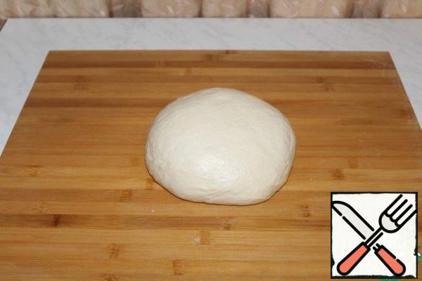 Knead the soft dough. Cover with plastic wrap and leave to rise for 1 hour.