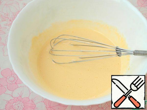 Beat the yolks with the sugar with a whisk until they light up. Add cognac to this mixture. Put the mixture in a water bath and continue to beat.