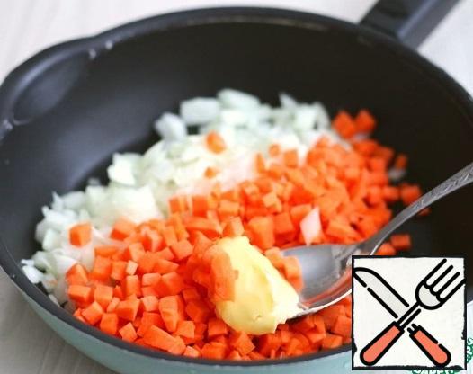 Add 2 tablespoons of vegetable oil to the pan, add 50 g of butter, put the carrots and onions.