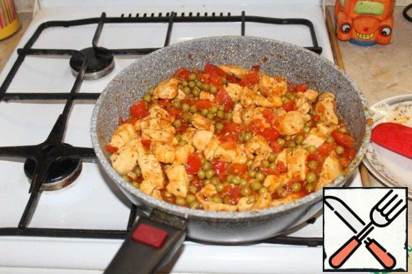 After a minute, add the tomatoes and green peas. Mix well.