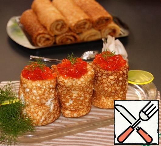 Put the pancake rolls on a skewer so that they do not spin and place the caviar on top.