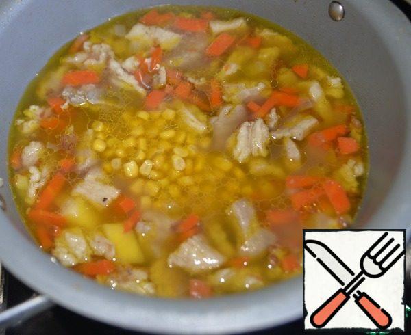 Take canned corn. Put the corn in the soup with the liquid.