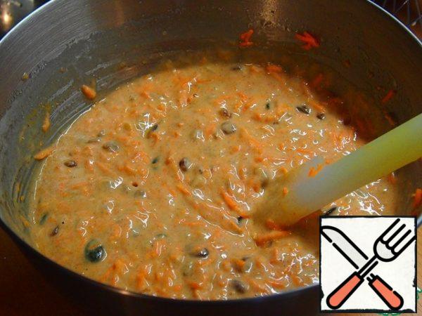 Add milk, carrots and a mixture of seeds, nuts and raisins and mix.