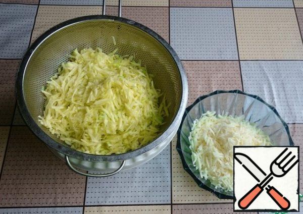 Grate the zucchini and cheese on a coarse grater. Finely chop the garlic.
Grated zucchini, squeeze out excess moisture.