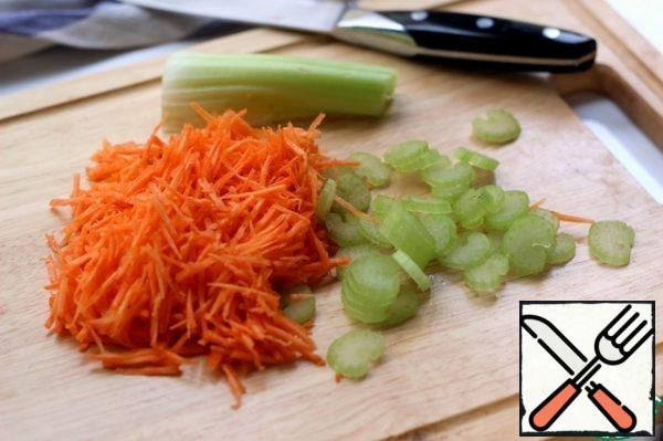 While the onion is being fried, grate the carrots, slice the celery and add to the frying.