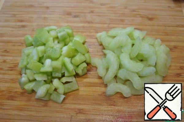 While the rice is cooking, prepare the vegetables, wash them and clean them. Pepper cut into small cubes, celery-thin slices. Peel and chop the onion. Defrost the beans at room temperature and dry them.