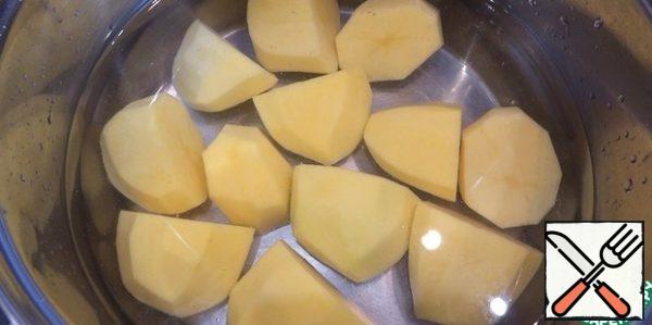 Washed and peeled potatoes cut in half and boil until ready in salted water.