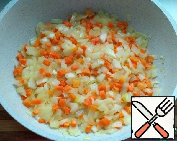Peel the onion and carrot, wash them, and cut them into cubes. Fry together in a pan in olive oil until the onion is soft.