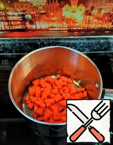 Put a pan on the stove at a high temperature. Pour in 2 tablespoons of olive oil. Then add diced carrots.