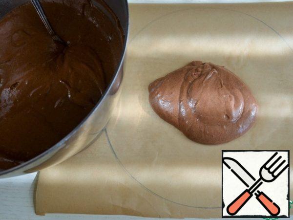 On baking paper, draw a circle, d-25-26 cm.. Flip over.
Put 2 tbsp of dough.