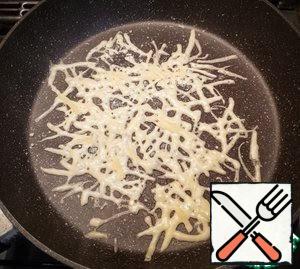 Pour 1/3 of the cheese into a hot, dry, non-stick frying pan.