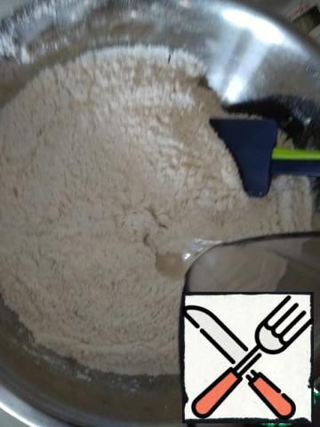 For the pita dough, mix flour, sugar, and salt. Add oil and hot water.