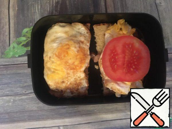 Top with eggs and a slice of tomato.