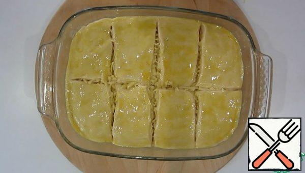 The last layer is smeared with yolk.
Cut the pie into squares and leave for 20 minutes in a warm place.
Bake at 180° for 40 minutes.