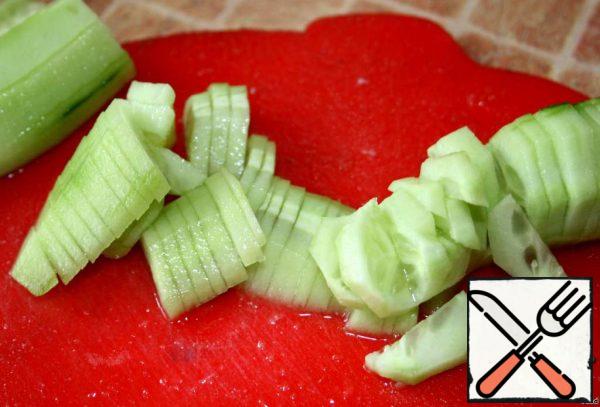 Cut the cucumber into cubes or strips.